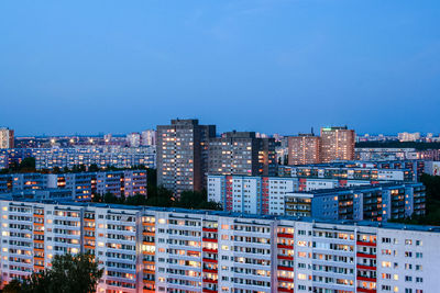 Buildings in city against blue sky