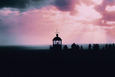 Silhouette of building against sky during sunset