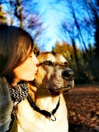 Close-up of woman with dog looking away