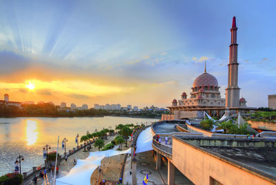 Mosque by river at sunset