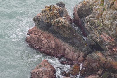 High angle view of rocks on sea shore