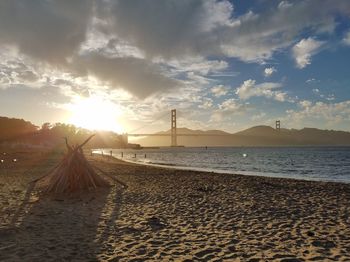 Scenic view of beach against sky during sunset