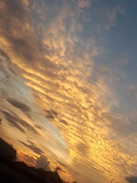 Low angle view of dramatic sky during sunset