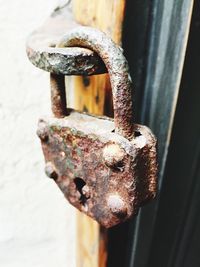 Close-up of padlock on rusty metal