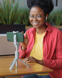 Portrait of young woman using mobile phone