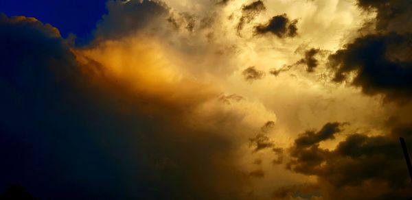 Low angle view of dramatic sky during sunset