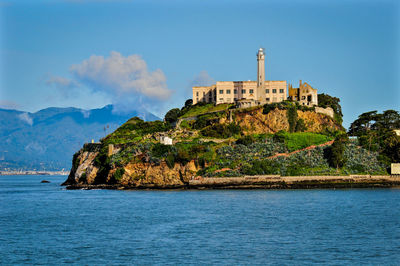 Scenic view of sea by building against sky