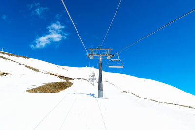 Low angle view of ski lift against sky