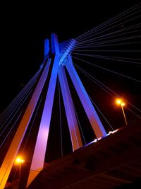 Low angle view of illuminated blue sky at night