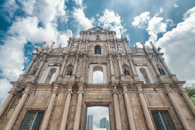 Low angle view of historic building against cloudy sky