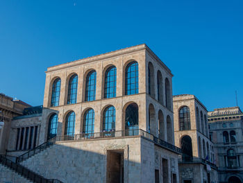 Low angle view of building against clear blue sky