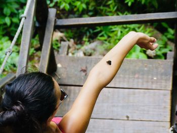 High angle view of woman with butterfly