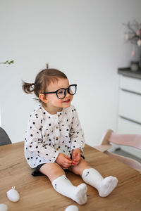 Cute boy playing with toy on table