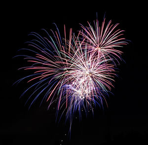 Low angle view of firework display at night