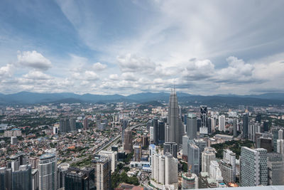 Petronas towers in city seen from menara kuala lumpur tower