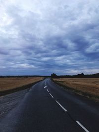 Empty road along countryside landscape