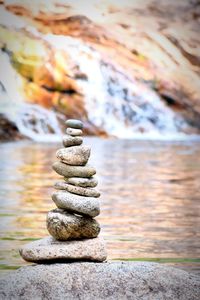 Stack of stones against lake