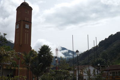 Low angle view of building against cloudy sky