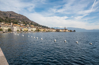 The lakeside of salò with the monte baldo in background