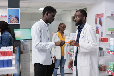 Side view of doctor examining patient in hospital