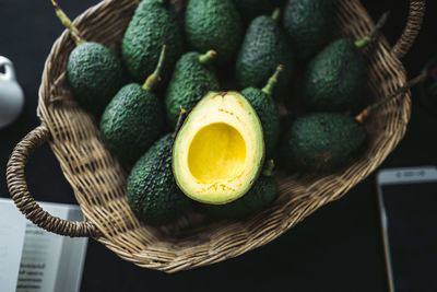 High angle view of avocados in basket on table