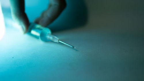 Close-up of human hand against blue background