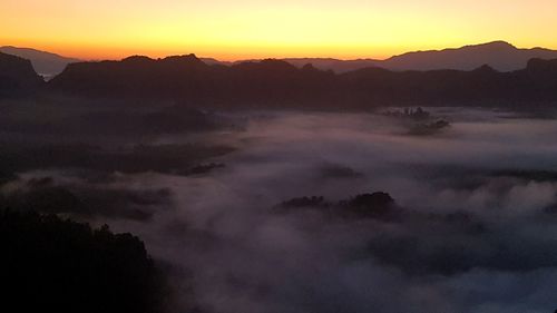 Scenic view of silhouette mountains against sky during sunset