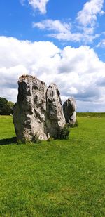 Rocks on field against sky