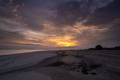 Scenic view of beach against sky during sunset