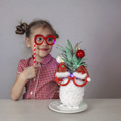 Portrait of woman holding christmas tree