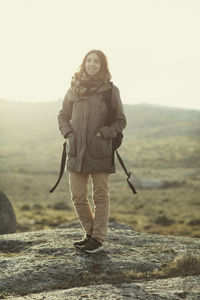 Portrait of young woman standing in snow