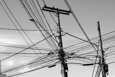 Low angle view of electricity pylon against sky