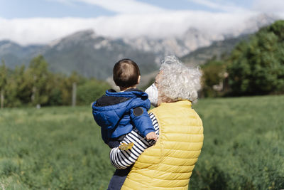 Rear view of father and son on mountain