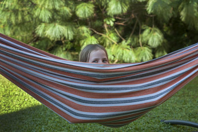 Portrait of girl lying on hammock