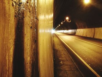 Illuminated tunnel at night