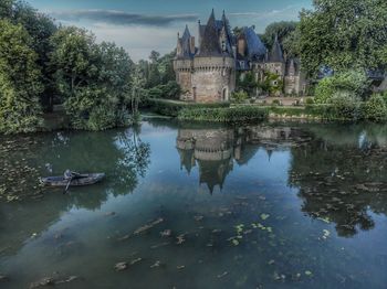 Reflection of trees and buildings in lake