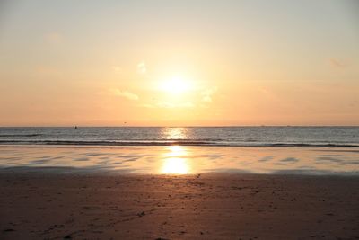 Scenic view of beach against sky during sunset