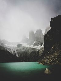 Scenic view of sea and mountains against sky