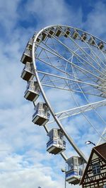 Low angle view of ferris wheel against sky