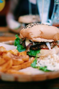 Close-up of french fries and burger in plate