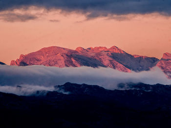 Scenic view of snowcapped mountains against sky during sunset