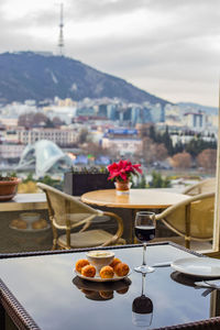 Close-up of drink on table against buildings in city