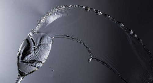 Close-up of water splashing against white background