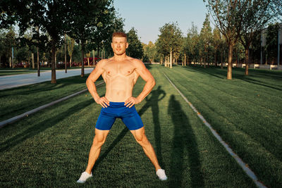 Portrait of young man standing on field