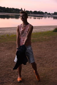 Full length of young man looking at lake
