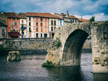 Disconnected and broken old stone bridge crossing the loire in brives-charensac, france