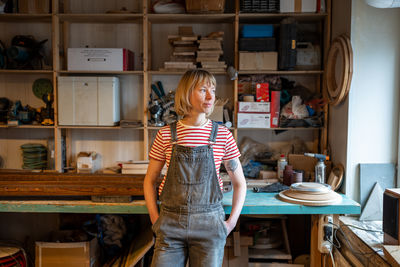 Portrait of young woman standing at home