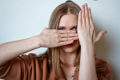 Woman covers her face with her hands