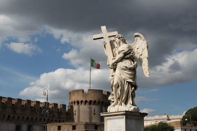 Low angle view of statue against cloudy sky