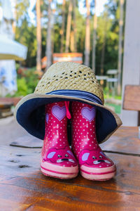Low section of woman wearing pink shoes